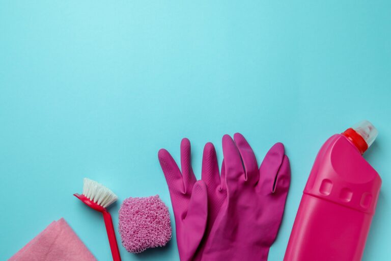 Cleaning concept with cleaning tools on blue background